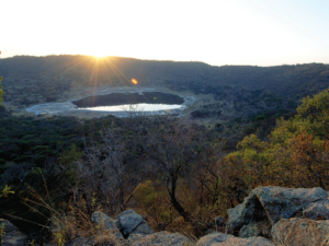 At 1.13 km across and 100 metres deep, the Tswaing Meteorite Crater features a shimmering saline lake.