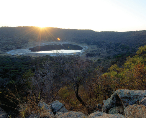 At 1.13 km across and 100 metres deep, the Tswaing Meteorite Crater features a shimmering saline lake.